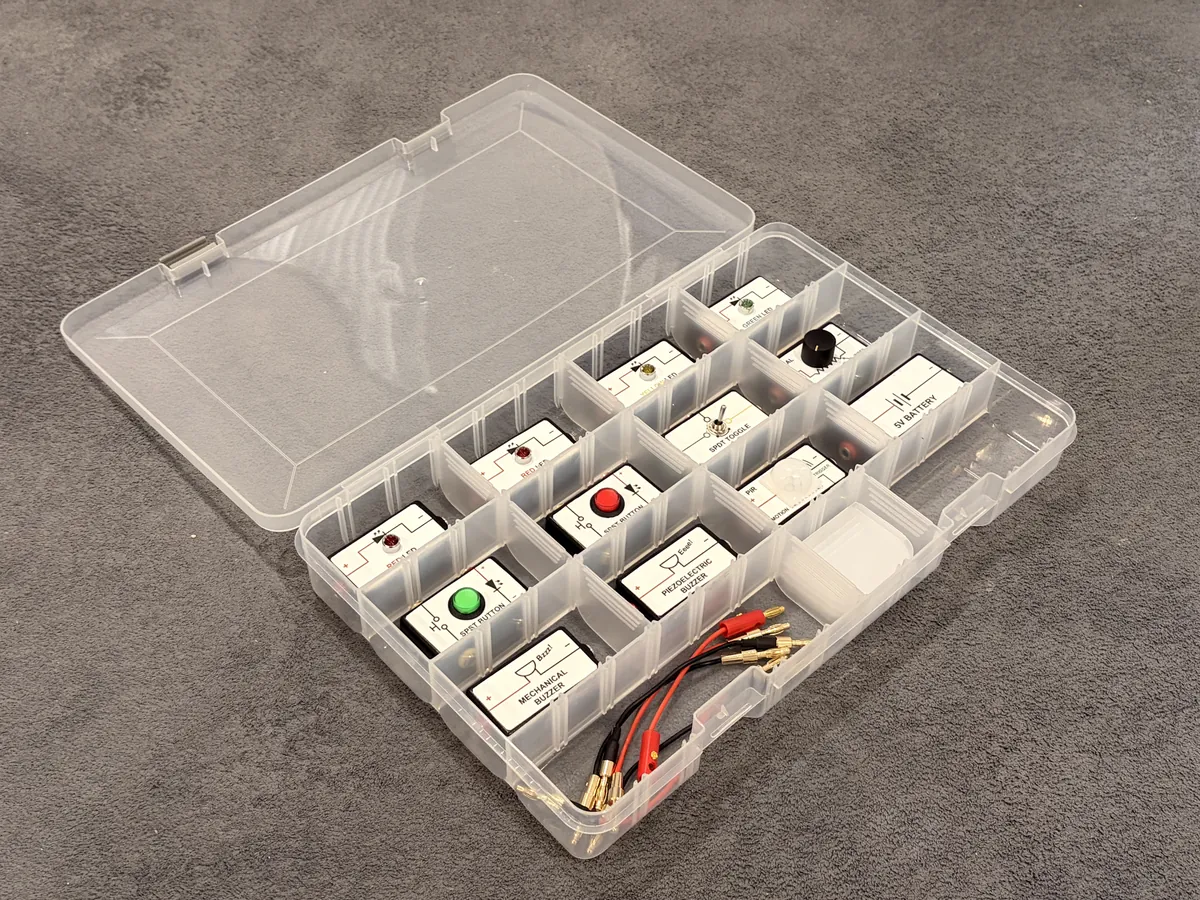 BushieBoy electronics modules, connection leads and accessories arranged in a storage case